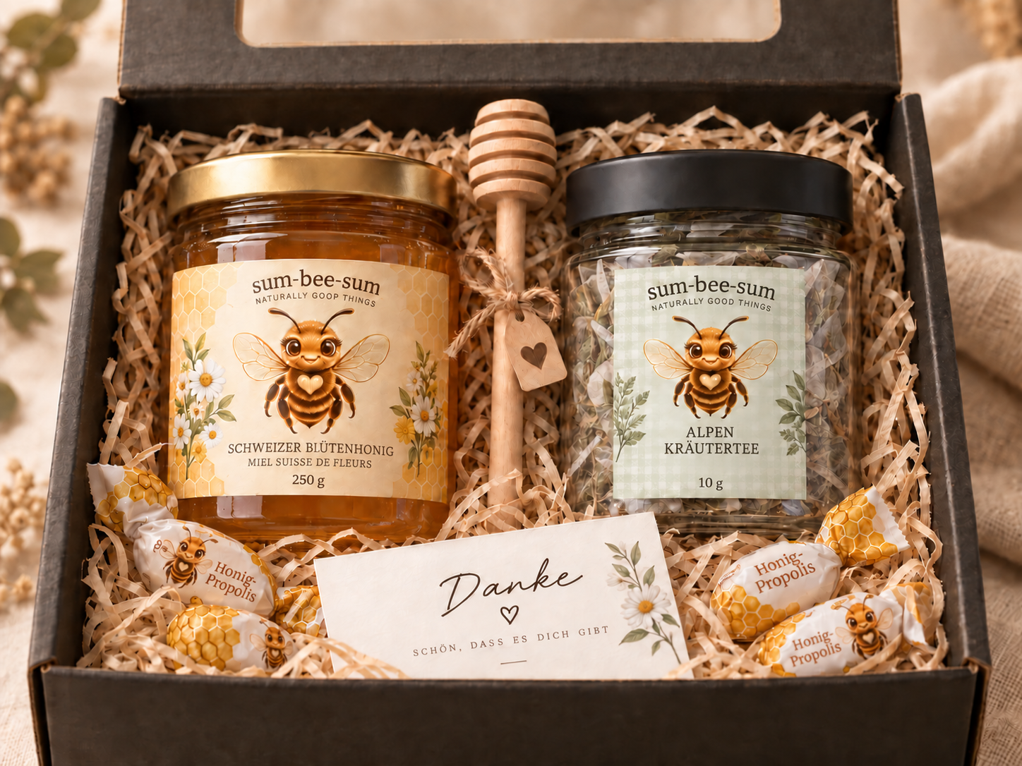 Schwarzes Geschenkset mit Honig, Tee, Honiglöffel und Dankekarte